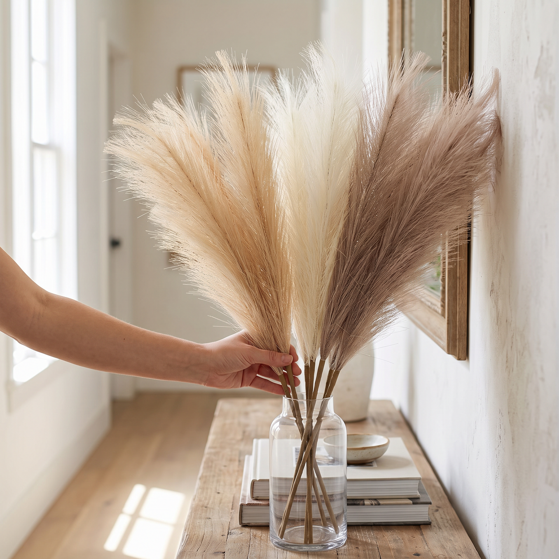 Hand arranging pampas stems into a vase