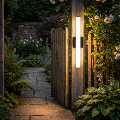 Wall light beside a garden gate at night