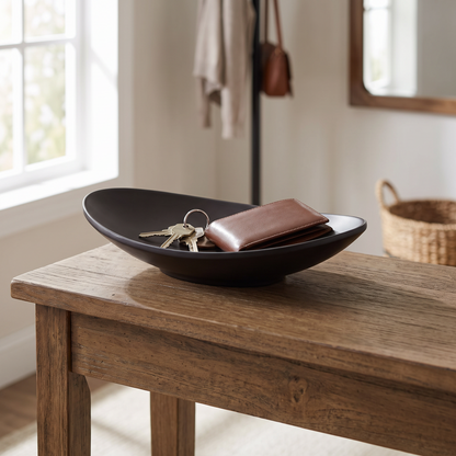 Oval tray holding keys on an entryway console