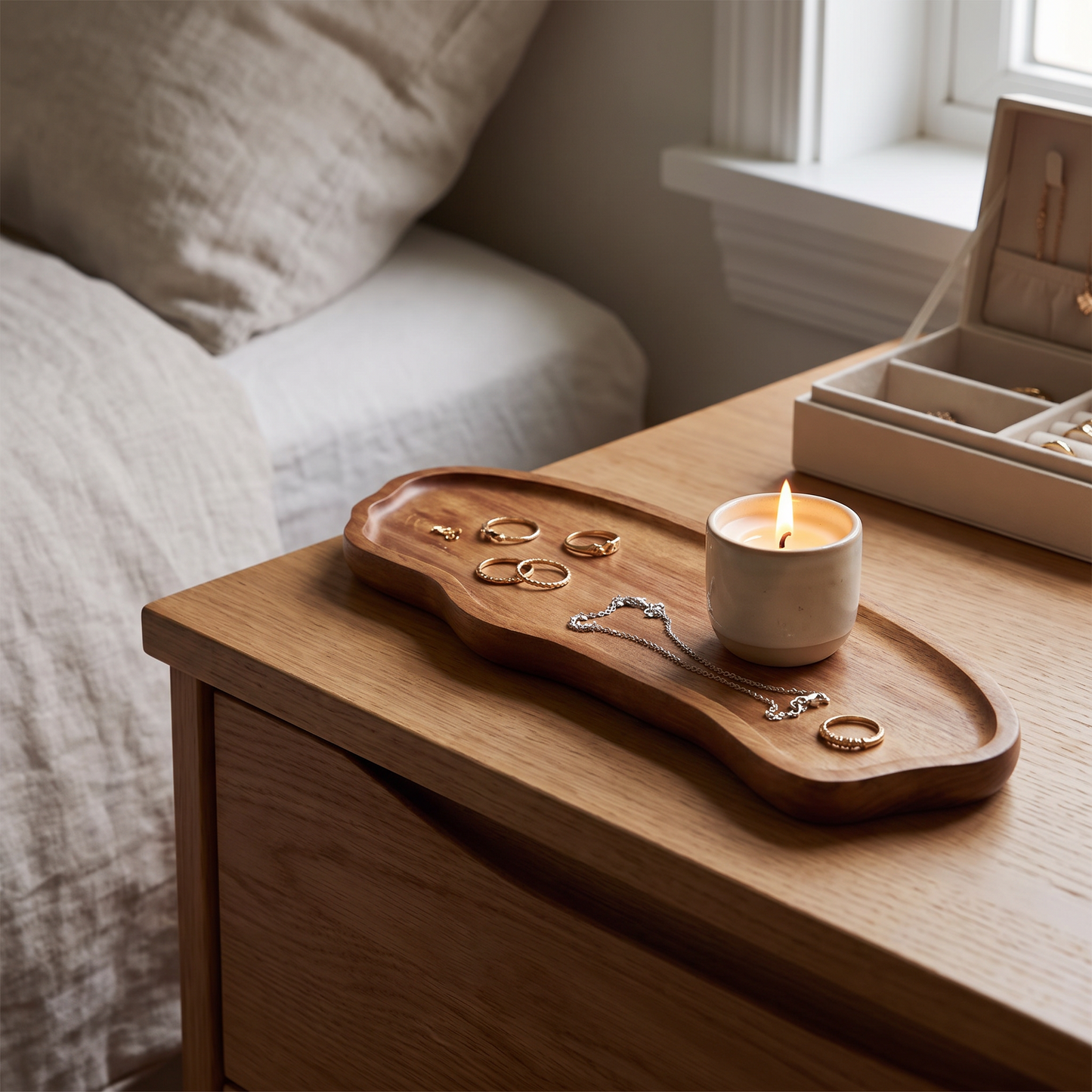 Tray on a dresser with jewellery and a candle