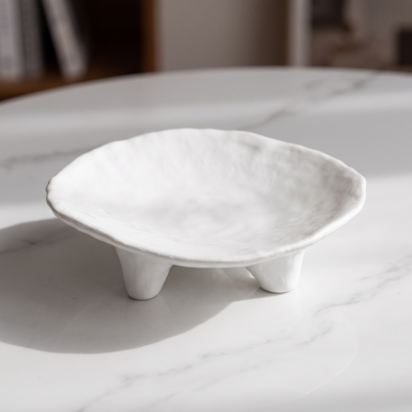 Close-up of the three-legged ceramic tray