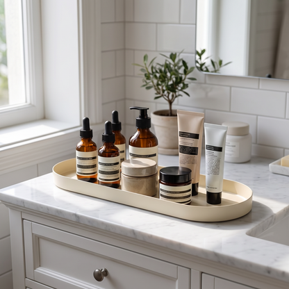 Tray holding skincare bottles on a vanity