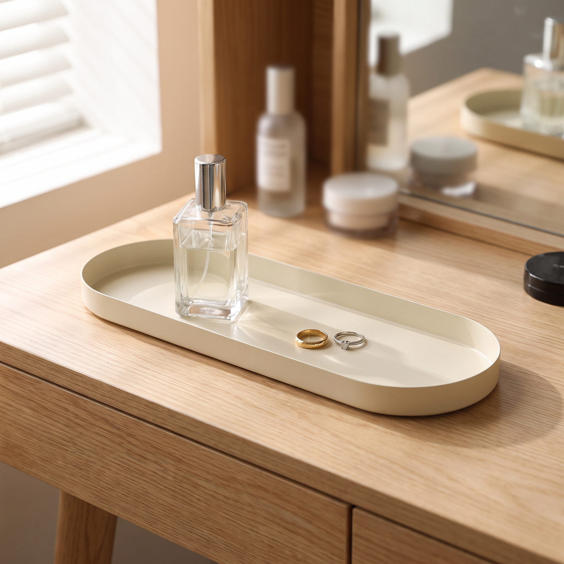 Oval tray with perfume and rings on a dressing table