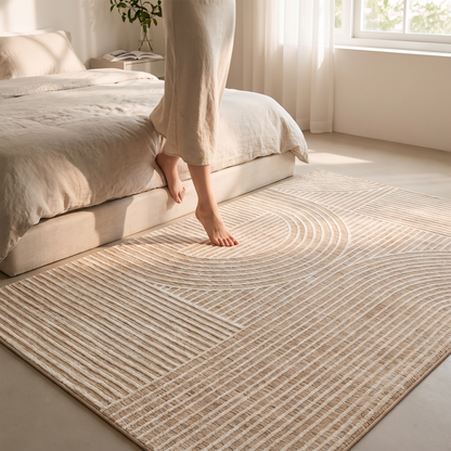 Rug beside a bed with bare feet stepping on